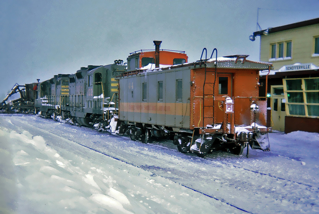 QNS&L GMD GP9 132 and 126 with Caboose No.44 and a Jordan Spreader No.27 used as a snow plow at Schefferville, Quebec December 27, 1969.