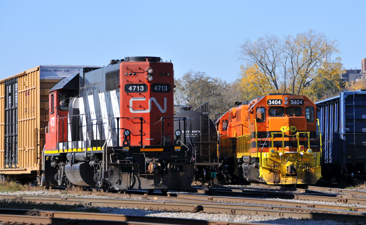 RLHH 3404 and RLHH 3403 idle away the afternoon away while tucked away in the yard at Brantford. They ultimately wouldn't depart for Nanticoke until around 17:30. To the left is 580 with CN 4713 for power, which is about to depart to switch both Mabe, and Rembos Inc on the Hagersville sub.