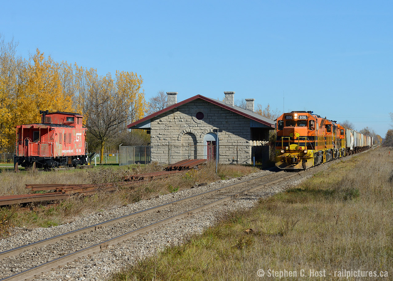 With some fall colour still abound - a rare weekend extra sees GEXR 516 with 17 cars of potash heading west for Agromart at Kellys (near Belton, Ontario). GEXR 516 is passing the former St. Marys station, built by the Grand Trunk in 1858 and used in railway service until the 1970's mostly as a  train order office for trains to/from the Forest sub. St Mary's more modern (1907) station is in use for VIA Rail closer to downtown. Note the GTW Caboose placed at the junction - which is now used as a off leash dog park. The caboose has seen better days. Why would a GTW Caboose be considered for St. Marys - a loose connection to the former Grand Trunk?? The Canadian Grand Trunk ceased to exist upon joining the CNR in 1923 - the connection between the two, in my humble opinion, is a loose one based on name only.