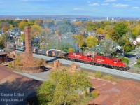 From up high, A CP Ballast train departs Kinnear on the former Toronto Hamilton and Buffalo Railway, with North Hamilton firmly in the background of this scene at the Brickworks. This ballast train was dumping between south siding switch kinnear and a spot near Rosseau Ave - with the track bed dug out completely (Ties sitting on dirt!) along much of the line, it's a wonder what's going on in Hamilton. New Siding extension? Clean-up after a Derailment? Anyone know?

