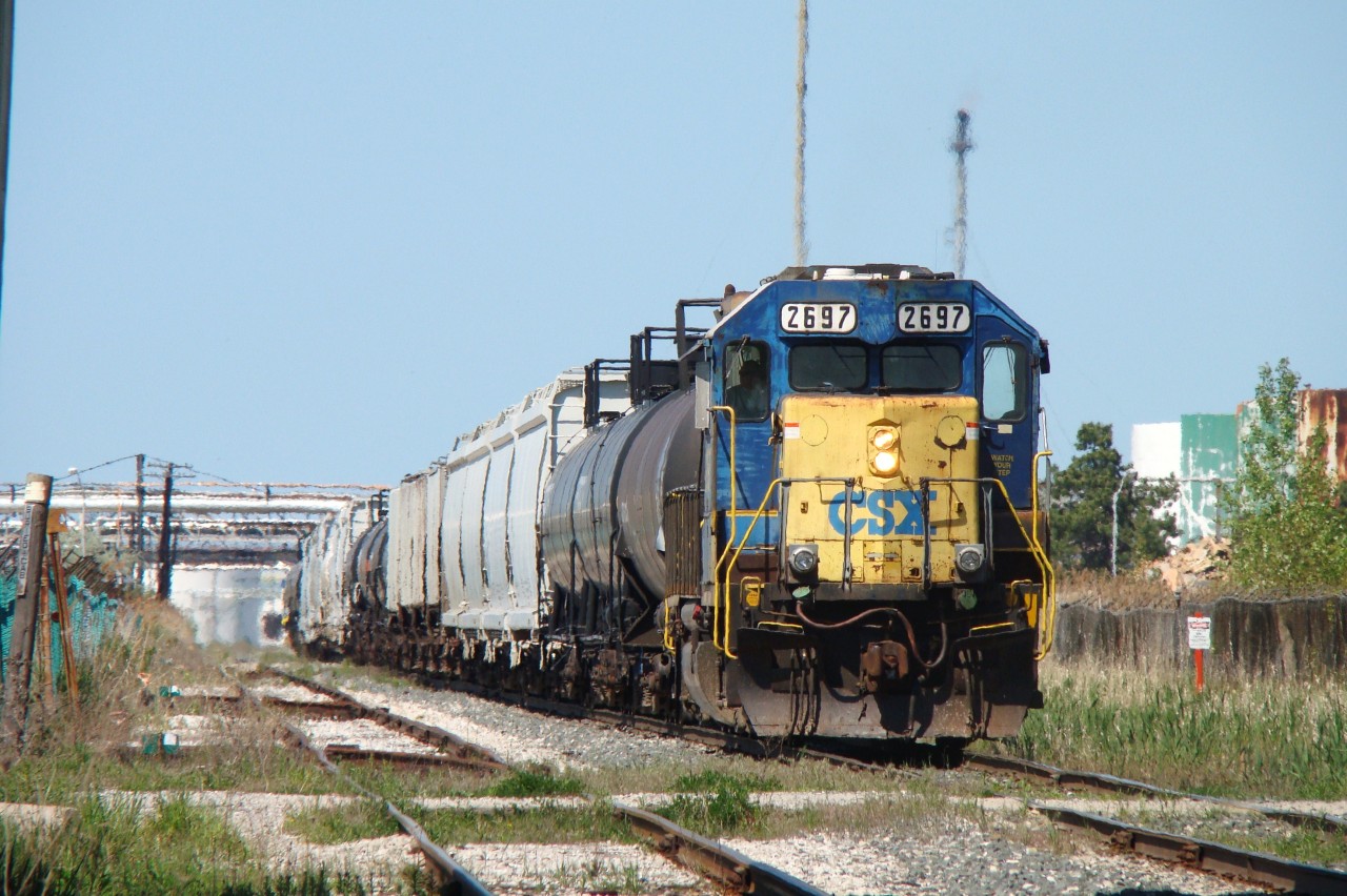 After spending a couple hours working the transfer to CN, the crew of 2697 are now backing their train into Sarnia yard where they will leave it for the afternoon yard job to pick apart. At the time, this was the last CSX unit in Ontario in the YN2 'bright future' paint scheme.