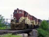 One can almost tell it is a hot, humid and hazy summer afternoon. TH&B 75, 403 and 76 power the Starlite from Aberdeen Yd in Hamilton back to Toronto; running a bit earlier than usual, giving plenty of light for a decent photo. The train is passing the Mile marker 37 at Bayview Jct., almost directly over top of the old Valley Inn Rd underpass. Times have changed.....the road is no longer open to vehicular traffic.