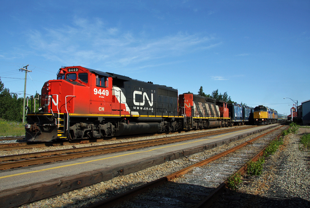 Bathurst Mines train with CN GP40-2LW 9449 and SD40-2W 5251 waiting for the VIA Rail to go by. VIA's lead unit F40PH-2 6424. August 08, 2009.