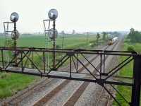 View of signal tower and westbound VIA Rail F40PH-2 6428, from route 1 overpass at Napanee West, Ontario June 29, 2005.