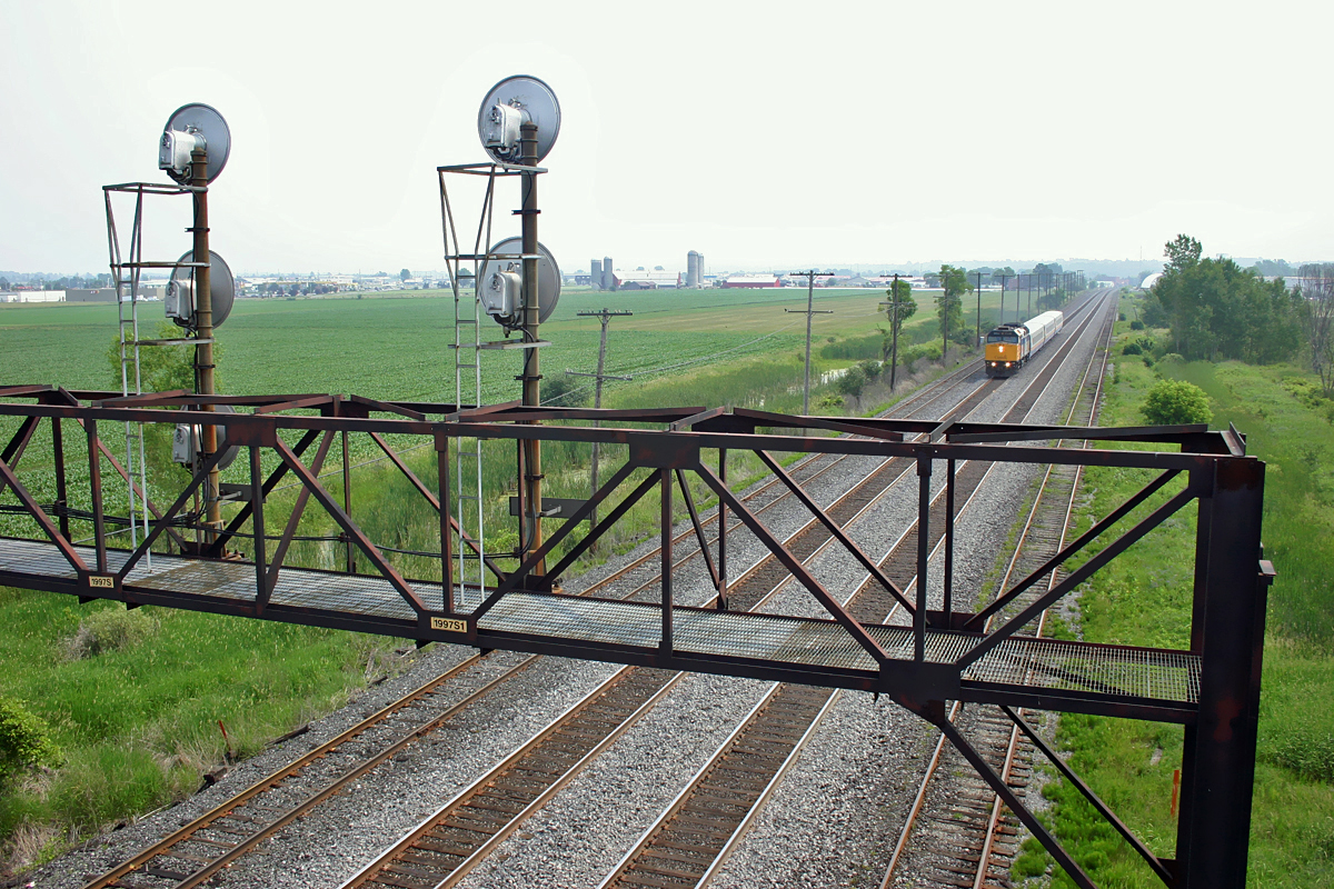View of signal tower and westbound VIA Rail F40PH-2 6428, from route 1 overpass at Napanee West, Ontario June 29, 2005.