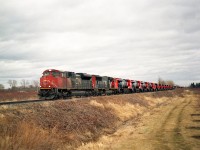 I have been lucky with these 'new power order' trains running the Grimsby sub as the orders of ES44ACs came across the border from Erie, PA's sprawling GE facilities. Here is another dozen behind CN 8019 and 5777 which came in the early spring of 2015. I elected to shoot digital for clarity. The camera failed in this case miserably, and all shots were useless,and since I was counting on lifting the engine numbers from the photos rather than my usual method of writing everything down on my hand as the train passes; my info here is lost. We know this is near the end of the most recent order, and I think this delivery consists of units numbered around 2960, give or take. I was fortunate to grab this film shot of the train as a backup as it came roaring by; and it was indeed an impressive sight to watch.