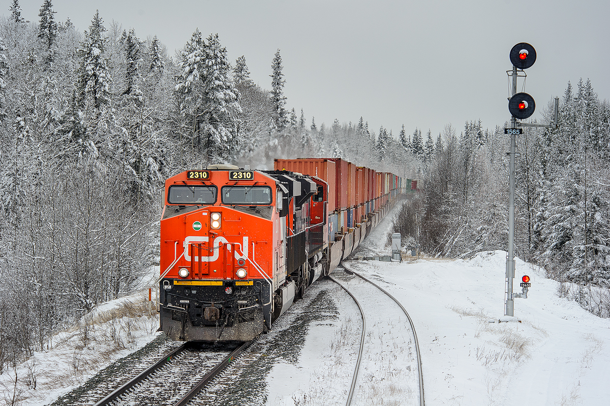 With a not particularly interesting consist on the point, Coquitlam-BIT train Q108 cruises over the west switch at Medicine Lodge amongst a winter wonderland.