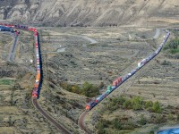 The race is on!! With both trains speeding towards a crew change at Kamloops, CP's Vancouver-Toronto hotshot 100-22 is seen at left while CN's Vancouver-Edmonton M31051 21 is seen at right. They're heading eastbound along the shores of the Thompson River just east of Ashcroft, BC.