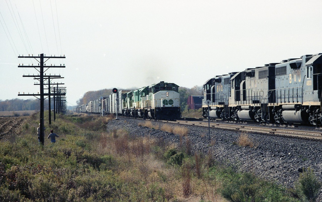 The weekend worriers and rent a wrecks meet west of London. Train 904 holds the bolted rail main while a west bound sits in the siding. (904,s power GO 706 72? 704 70? The west bound B&O 4809 C&O 4820 B&O 4800 and not in the picture CP 421? . Power short CP would get as many GO units as possible on Friday nights. Run threw to Windsor back to Montreal , then return to Toronto for servicing and the Monday morning commute.