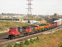 The Hopkins street over pass in Whitby has provided a good location and a variety of treasures over many years. On this fall day in October 1999 a CN west bound lifts cars from Oshawa yard. CN 2588 6021 BNSF  in transit 7335 7338 7333 and CN 5319 with another unidentified dash 2 provide the power. The BNSF SD40,s are ex CN units rebuilt in Montreal . 