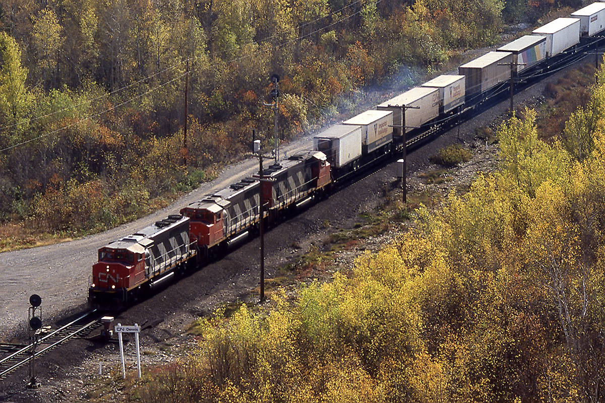 Driving the service road north from Capreol yard, probably forbidden down leads to Dennis where 2 tracks to the yard begins and CTC ends. Climbing the fairly steep hill across the the tracks yields this shot of 217 ( the pigs up front are a dead give a way) heading west for Vancouver. The typical 3 GP40-2's that CN seemed to put on almost everything in eastern Canada lead 7000 feet of train westward.