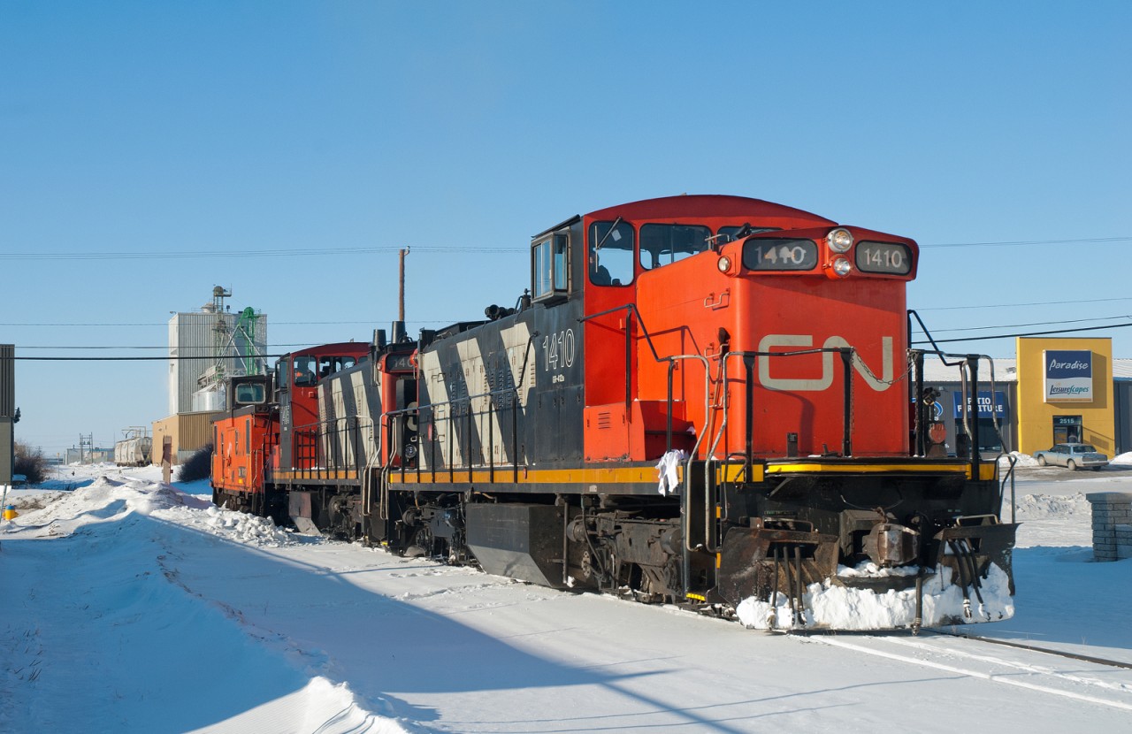 CN 1410, 1405, and caboose 79431 are seen on one of the many industrial spur's in Saskatoon's north end on a bone chilling -44C day.