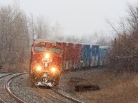 With just over 700 axels CP 142 left Toronto with a Monster size train . 142 comes round the curve into Lovekin with 9353 upfront and KCS 4618 mid train for the Toronto to Montréal portion of its trip. 