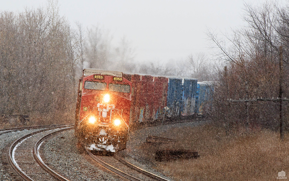 With just over 700 axels CP 142 left Toronto with a Monster size train . 142 comes round the curve into Lovekin with 9353 upfront and KCS 4618 mid train for the Toronto to Montréal portion of its trip.