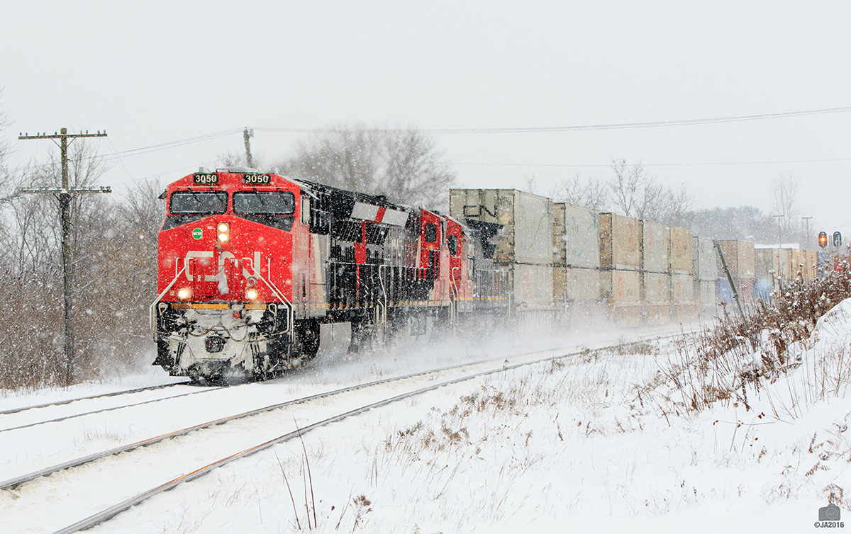 Winter has arrived, Q149 rounds the curve at the east end of Ingersoll. With Consecutive numbered ET44AC's. 3050,3049 and 2018 take charge on this Chicago to Montréal hot shot.