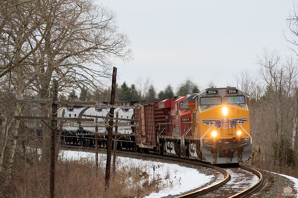 A pair of GE's take charge on this empty ethanol snake westbound through Southern Ontario. UP 5506, CP 8804 waste no time as they race across the countryside.
