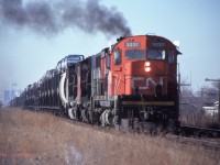 CN 3237-9667-9591 start train no. 422 away from Windsor with open multi-levels of Dodge pick-ups in tow.