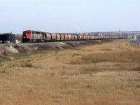 A grain train arrives in Edmonton. The tank at far left is for a contaminated water collection system for the the old Domtar creosote plant.
 On the horizon, above and to the left of the train is Celanese and the colourfull stacks belong to a Fiberglass plant, I believe.
