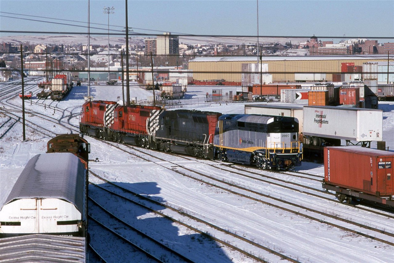 This was odd, even for CP. an Amtrak California F-59PHI in Calgary. Presumably, it was being delivered to California from London? It seemed strange that it would be routed through Calgary, though.
I am assuming that the ex SP SD-45 is being leased by CP.
The tiny Intermodal yard is in the background.