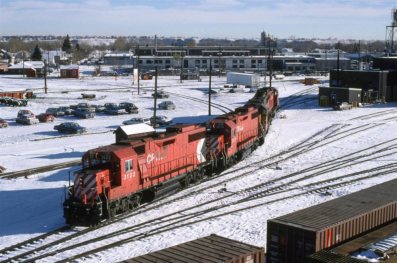 a set of four-axle power comes off the shops at Alyth. I wasn't there long enough to see where this was headed.
Amazingly, that building in the background still exists. In fact, it has been renovated. CP also took out the wye just to the left of the photo range and put in a turntable more or less above the trailing unit. Overall, the area is a lot more sterile.