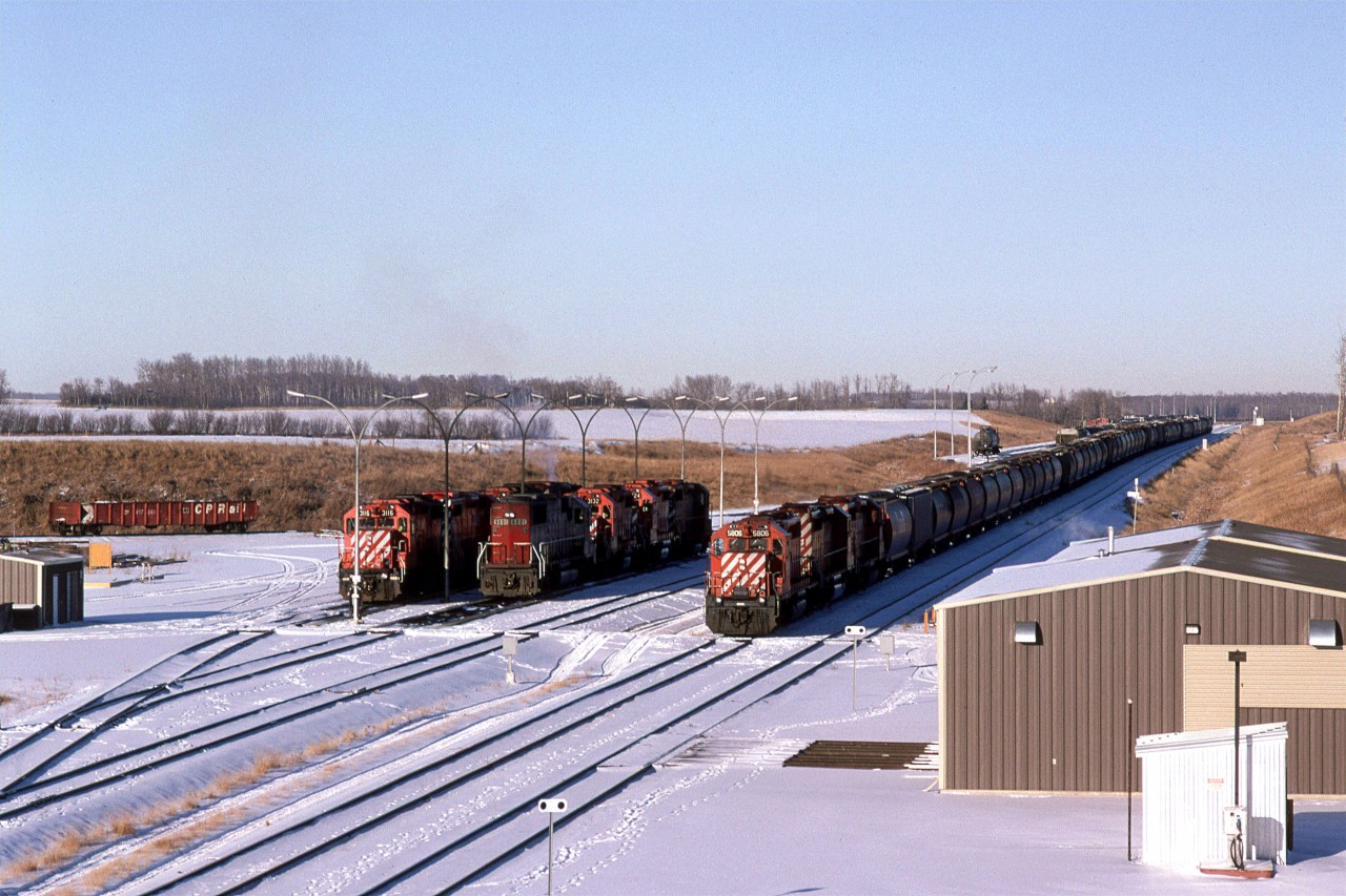 We rarely stopped in Red Deer as we traveled between Calgary and Edmonton, until the re-routeing of the CP ROW occurred, and the yard became visible from the highway. On this day, there was a southbound train ready to leave and several local engines resting. One of which was in SOO colours.