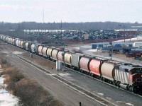 This was a relatively common site on CN - an empty grain train of 100 hoppers, with only one locomotive to get the train over the line. CN's grades were not that significant, and they probably relied on the shop crews to keep their locomotives in fine working order.
