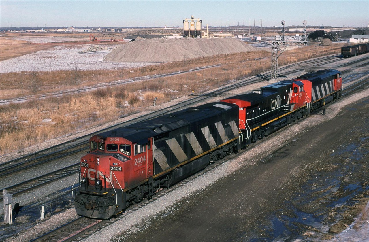 This is my first spotting of a GE DASH 9 on CN (The second unit). This power set will back on to those empty coal gondolas in the background, perform a brake test, and then proceed west to the Hinton area to be loaded.