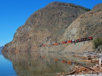 An eastbound Intermodal is reflected in Kamloops Lake as it approaches Kissick behind CN 2707.