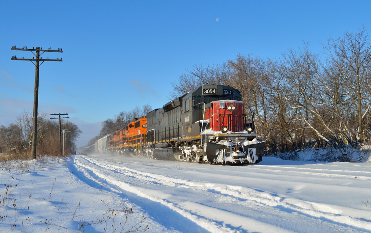 On a frigid December morning, as evidenced by the nose of 3054, GEXR 432 kicks up the snow as it comes off the downhill grade into Guelph with 258 axles on the drawbar.