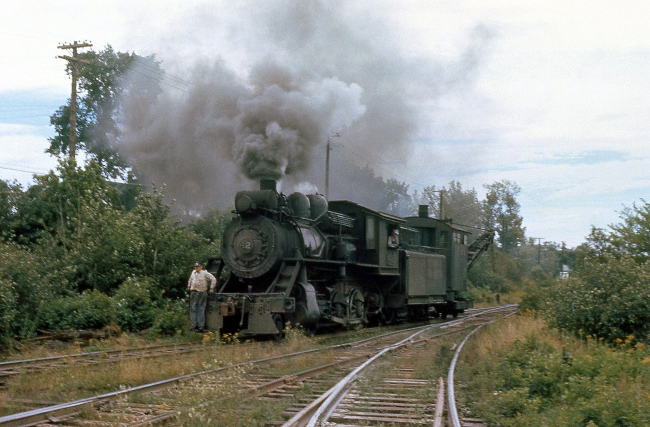 Acadia Coal Company 2-6-0 42 handles a steam crane at their colliery (mine) in Stellarton, Nova Scotia in August 1961. The crane was working on some trackage in the yard, and 42 is shown here taking her back to the shop in the late afternoon.

Build by Alco (Schenectady NY) as Dominion Coal 2-6-4T 16 in 1899, the unit became Sydney & Louisburg 42 not long after in 1901 (who eventually converted it into a 2-6-0). 42 was sold to the Acadia Coal Company in 1955, used to switch and handle coal hoppers at their mine operations. After acquisition by a private owner in 1963, and operation on tourist railroads Cape Breton Steam Railway, and the Salem & Hillsboro, 42 was donated to (and currently resides at) the Nova Scotia Museum in Stellarton, NS in 1983.

(Original photographer George Schaller, duplicate slide from the collection of Bill Thomson and posted on behalf of and with Mr. Schaller's full participation).