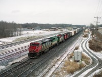 This is a familiar location for the train junkies of the Golden Horseshoe area. I am by the Waterdown Rd bridge shooting north, with the under-construction Aldershot GO facility in the background. Westbound CN 2425 is assisted by 9676 (x-GO 709), 9401 and 4537. Note location of the Aldershot yard back then...way down the line.It has expanded considerably since this photo. Great opportunity for a very interesting Time Machine followup, only problem is, the area has expanded to the point it is almost dangerous wandering along the side of the road there; not the quiet of days past.