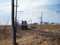 Another photo taken along the Canada Crushed Stone line that ran between the quarry north of Greensville and the dumper at Dundas, showing one of their electric dump motors traveling along the double-tracked section, and the overhead catenary that supplied power for electric operation on the line