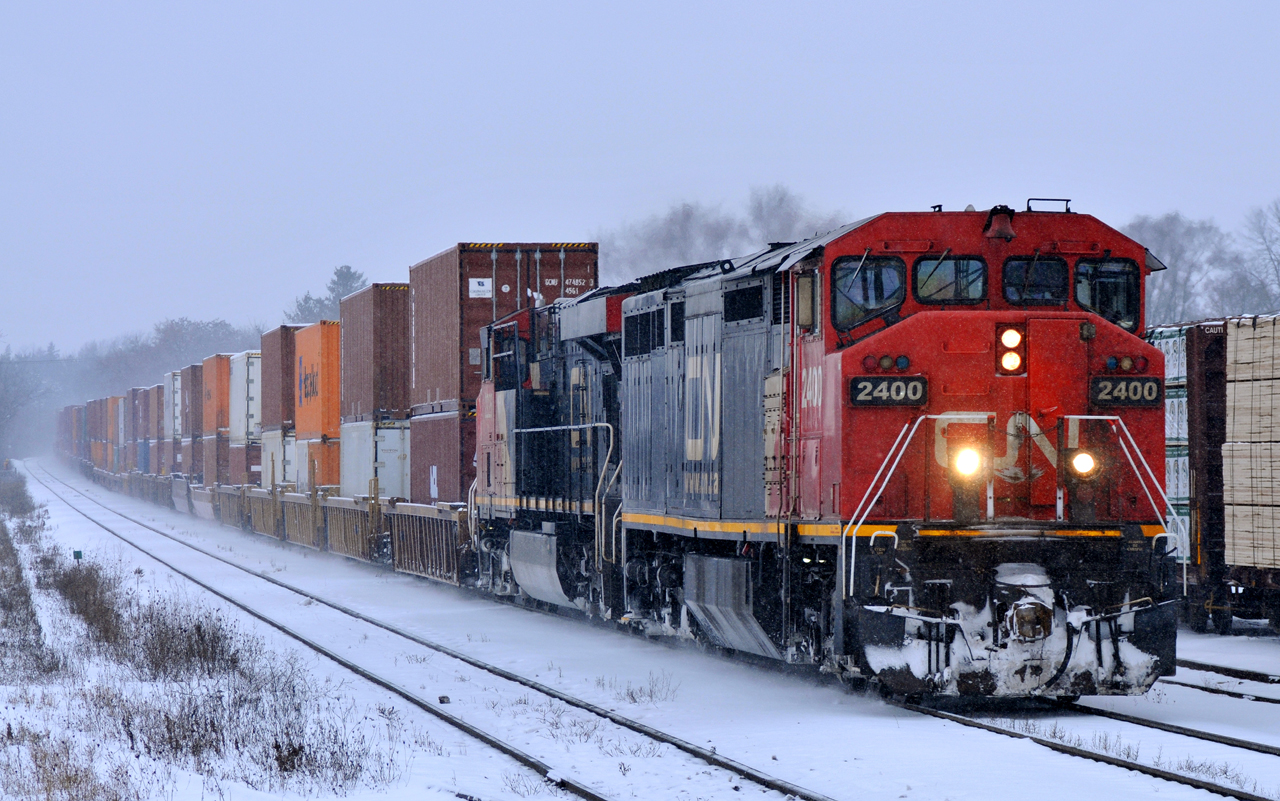 Q14891 12 rolls through Brantford with CN 2400, CN 2226, and 178 cars.