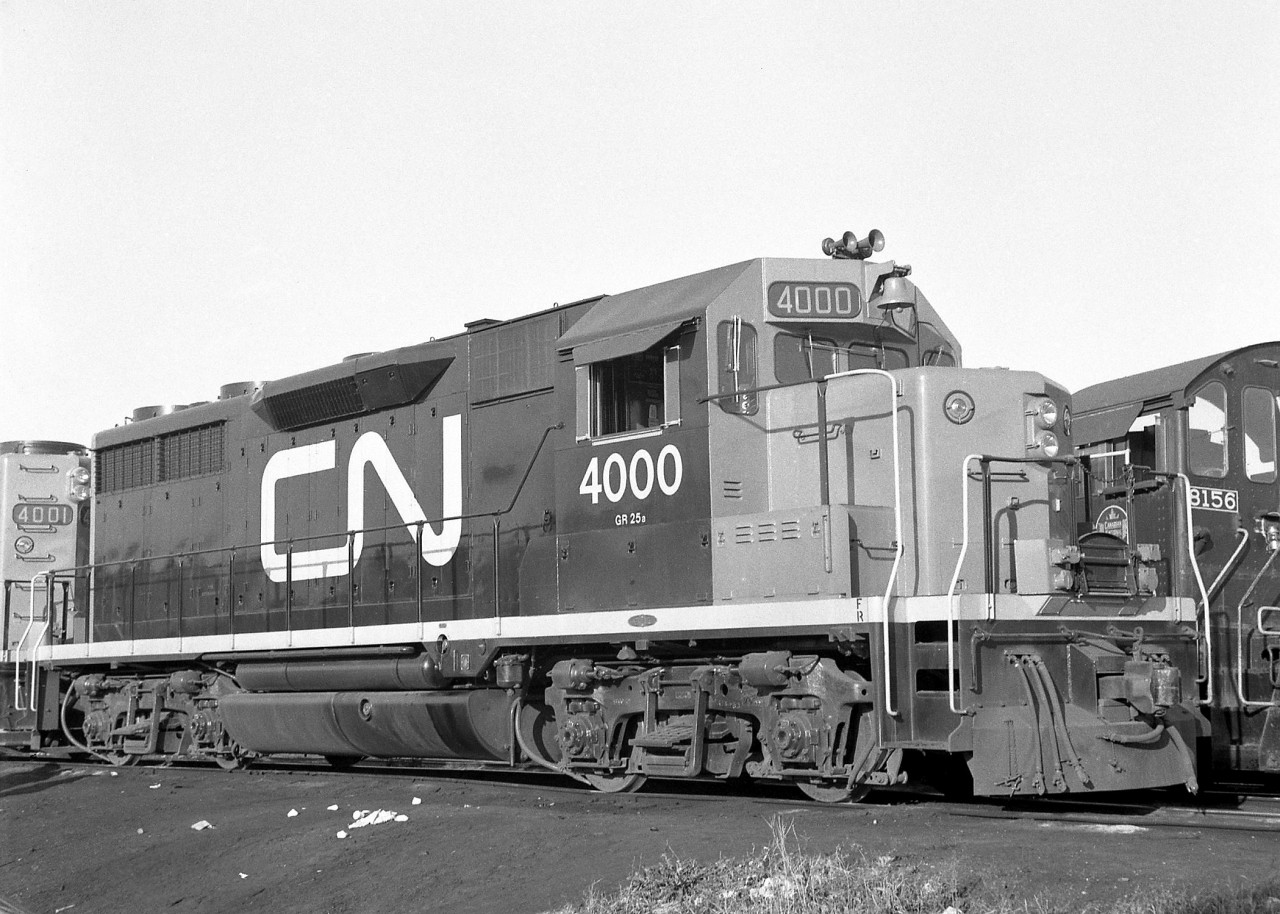 Brand new CN 4000, with sister 4001, pose at Mimico Yard in October 1964. The only two GP35's CN ever ordered, they were built at GMD London in 1964 with what were "Canadian" spotting features not typically ordered on American models (headlight on the nose, bell on the cab, vertical steps and handrails). CN didn't place any follow up orders with GMD for GP35's, but did follow through two years later for 16 of the improved model: the GP40, followed by over 200 widecab GP40-2L/W unit starting in 1974.

CN's pair of GP35's, oddball units on the roster, were renumbered 9300 and 9301 before being retired in the mid-1980's. CN 4000/9300 went on to operate on the Dakota, Missouri Valley & Western as their 323, where it resided until being scrapped in 2002.

CN 4001 at Mimico on the same day: http://www.railpictures.ca/?attachment_id=26650