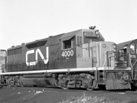 Brand new CN 4000, with sister 4001, pose at Mimico Yard in October 1964. The only two GP35's CN ever ordered, they were built at GMD London in 1964 with what were "Canadian" spotting features not typically ordered on American models (headlight on the nose, bell on the cab, vertical steps and handrails). CN didn't place any follow up orders with GMD for GP35's, but did follow through two years later for 16 of the improved model: the GP40, followed by over 200 widecab GP40-2L/W unit starting in 1974.
<br><br>
CN's pair of GP35's, oddball units on the roster, were renumbered 9300 and 9301 before being retired in the mid-1980's. CN 4000/9300 went on to operate on the Dakota, Missouri Valley & Western as their 323, where it resided until being scrapped in 2002.
<br><br>
CN 4001 at Mimico on the same day: <a href=http://www.railpictures.ca/?attachment_id=26650><b>http://www.railpictures.ca/?attachment_id=26650</b></a>