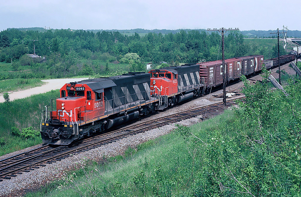 CN Rail GMD SD40 No.5082 with GP40-2LW No.9422 E/B leaving Bathurst, July 03, 1983.