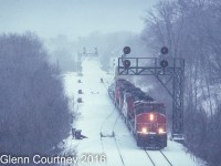 Before today's higher speed switches and triple track an eastbound led by SD40-2W 5314 rolls off the Dundas Sub and on to the Oakville while heavy snow falls. There's even a maintainer on hand to help keep the switches clear of snow. 