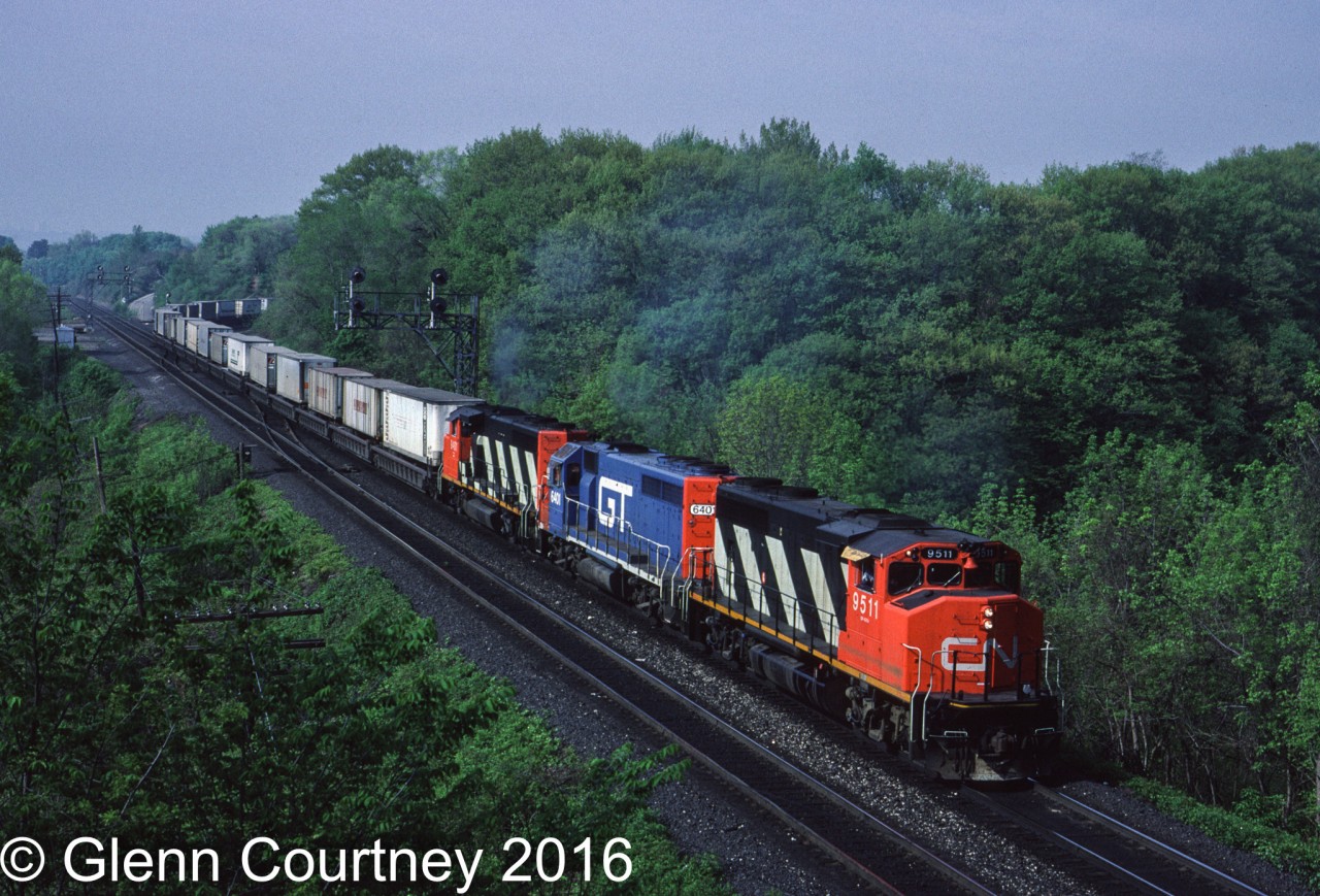 Another Bayview shot, almost 10 years before the last one I posted. The eastbound Laser has travelled overnight from Chicago. Today's train has a GTW GP40-2 (former DT&I) as the meat in a GP40-2W sandwich, this was fairly common on the Laser. Also note that there is nothing but trailers in well cars on the head end of the train.