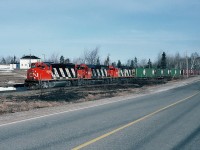 CN GP40-2LW 9586, SD40 5078 and MLW C-630M 2028 eastbound near Rogersville, New Brunswick. April 20, 1991.