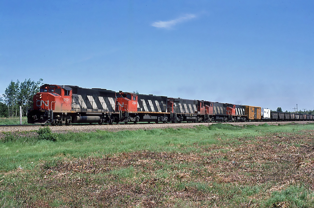 CN GMD GP40-2LW 9591 and four MLW M-420W's with a northbound work train at Belledune, New Brunswick June 13, 1987.