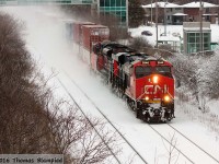 Round two of the winter storms in the Toronto area begins to subside as a westbound double-stack rolls through Whitby.