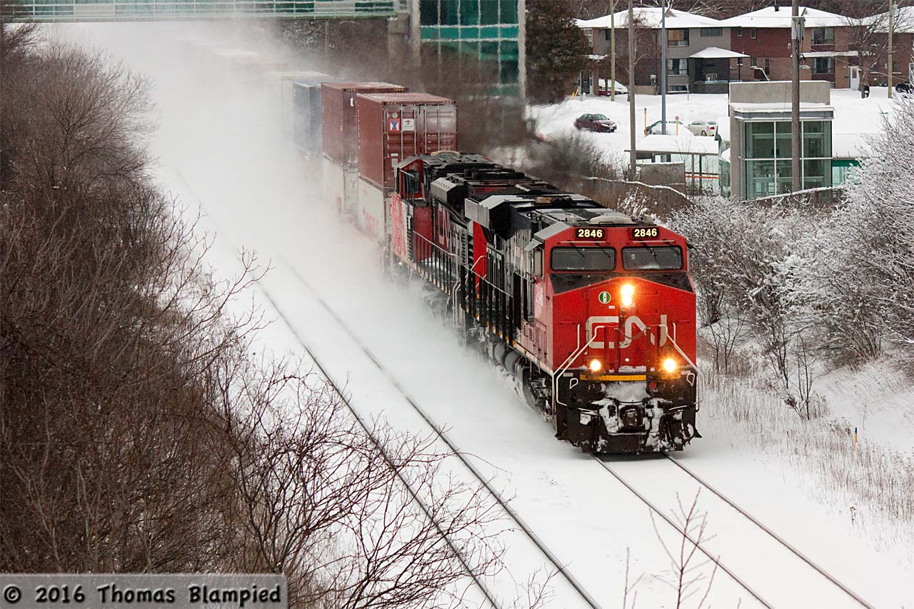 Round two of the winter storms in the Toronto area begins to subside as a westbound double-stack rolls through Whitby.