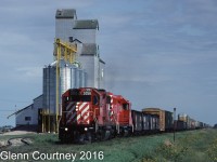 CPR GP38-2 3056 is leading Winnipeg - Emerson train #560 past the Manitoba Pool elevator at Fredenstahl West on the outskirts of Emerson. I believe that this elevator has been demolished. #560 exchanged cars with both Burlington Northern and Soo Line at the border (Emerson, MB / Noyes, ND).