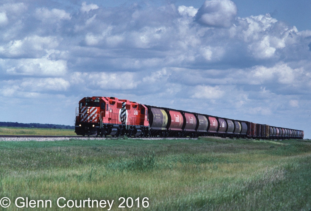 Rolling along the prairie on the Carman Sub the Carman Turn has brightened up what was a slow day on the railway. The Carman Turn seldom ran to Carman and today only went as far as the Cargill elevator in Elm Creek.