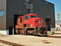Here we have a GE AC4400 with it's nose poking out of the east end of the Diesel Shop. The locomotive is having it's HVAC unit changed out (on the ground to the right of the pilot) the door under the engineer's side is open to assist in aligning the unit in.