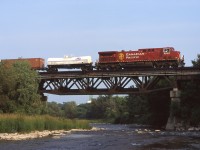Good old CP 153 (formerly 503) crosses the Credit River in Streetsville ON with one of it's trademark tankcar's on the head end. 