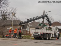 <b> How many people does it take to change a bulb? </b> It was the calm before the storm...before the snow started to fall,  as I was able to capture a different perspective that sometimes is a hard one to get. A different take this day for the Canadian Pacific - the crew installing new crossing barriers at the Jeffrey Street location in Chatham, ON. A rail lovers dream of the treasure that sits on the ground from the former protective barriers.But this one goes to the men and women who serve in this capacity, keeping all railfanners alike safe and sound.