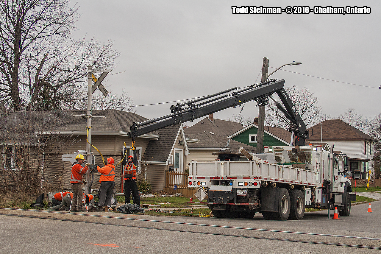 How many people does it take to change a bulb?  It was the calm before the storm...before the snow started to fall,  as I was able to capture a different perspective that sometimes is a hard one to get. A different take this day for the Canadian Pacific - the crew installing new crossing barriers at the Jeffrey Street location in Chatham, ON. A rail lovers dream of the treasure that sits on the ground from the former protective barriers.But this one goes to the men and women who serve in this capacity, keeping all railfanners alike safe and sound.
