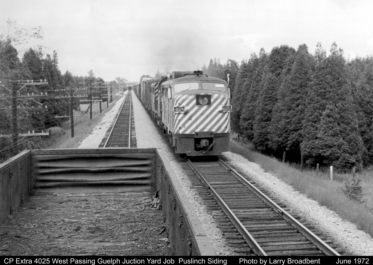 Busy Day at Puslinch Siding for the Guelph Jct Yard Job as it spreads Ballast and Ties. Extra 4025 West passes with a pair of FA's and a RS23.
