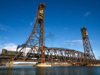 A 1959-built Montreal Locomotive Works S-13 chugs across the Dain City lift-bridge with a cut of cars from Atlantic Biodiesel.

I'm hoping that locals can share more photos of this beautiful structure, past or present. Arnold Mooney, I'm looking at you! :)